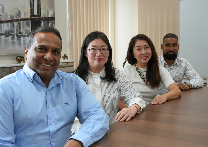 Financial Advisors and team at JR Finance in the office at a table